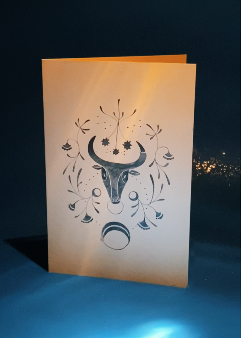 Decorative bull watercolor painted card design on a dark blue background with glitter